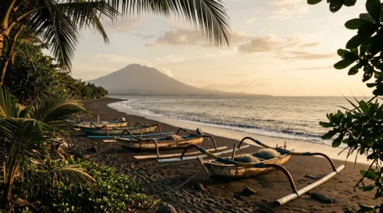 Vue paisible d'une plage balinaise préservée avec barques de pêcheurs traditionnelles et végétation tropicale au premier plan